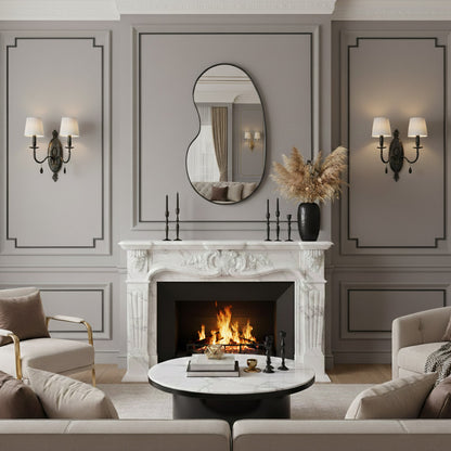 Black kidney mirror over classic fireplace mantel.