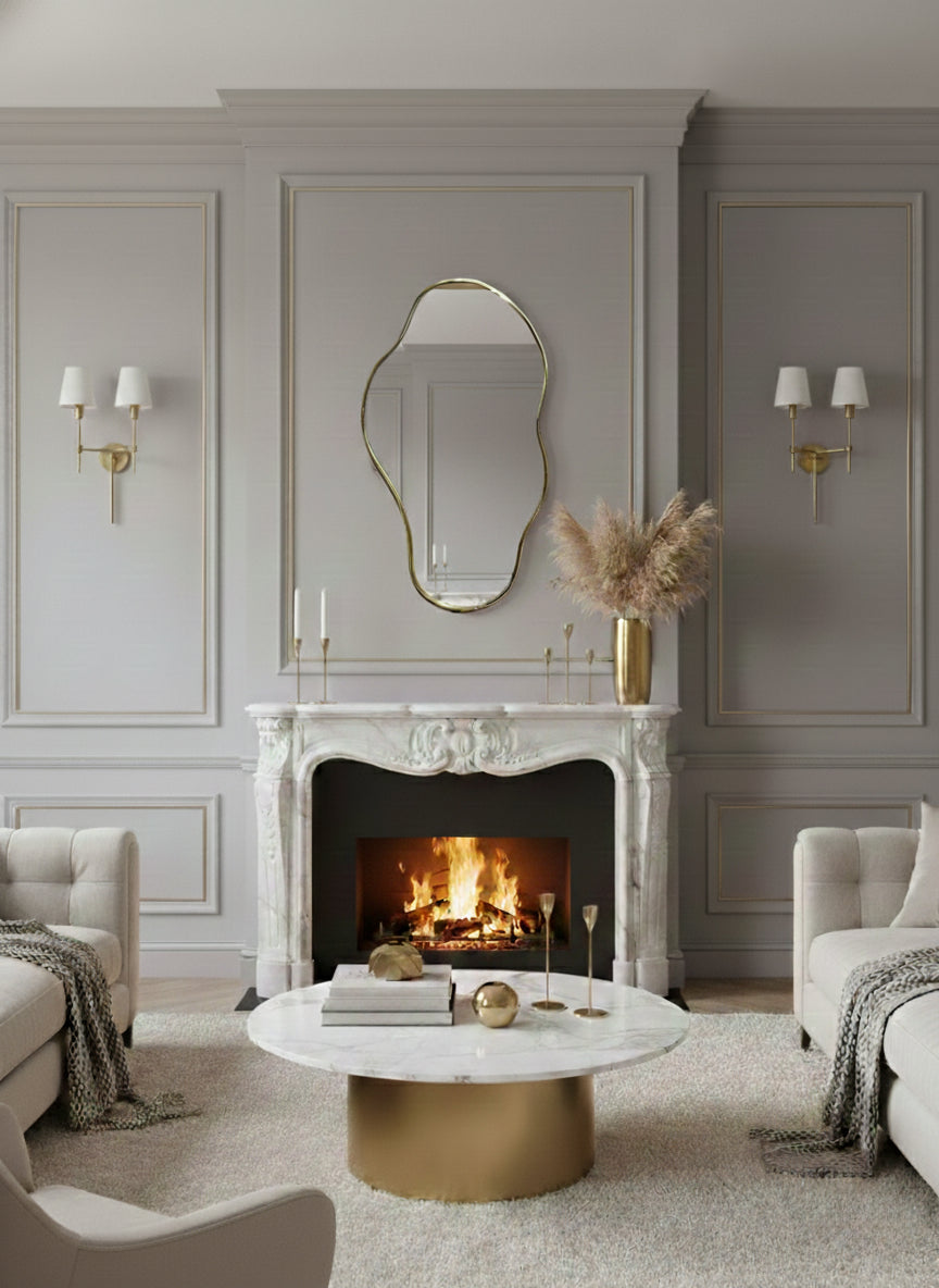 Organic brass mirror above marble fireplace