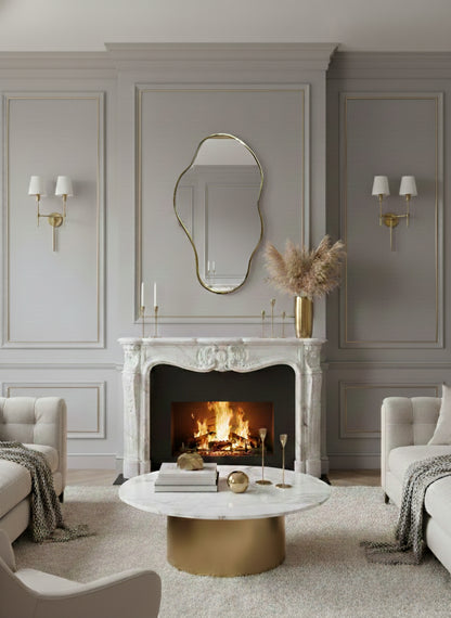 Organic brass mirror above marble fireplace