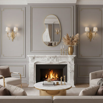 Kidney-shaped brass mirror above marble fireplace.