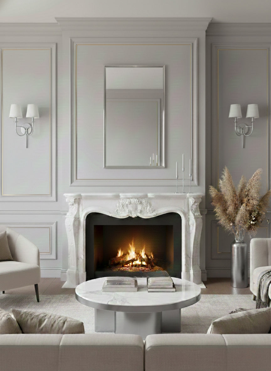 Silver rectangular mirror above marble fireplace.