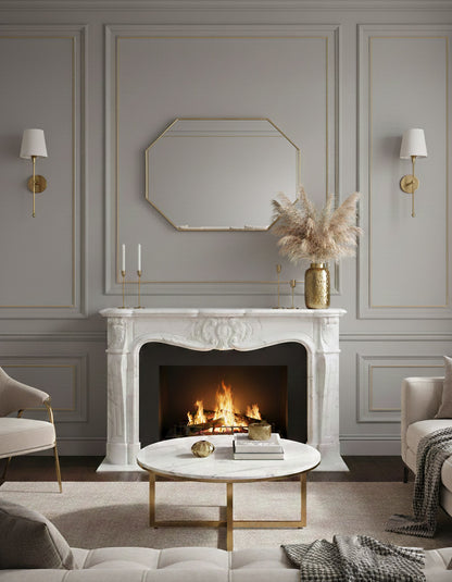 Octagon brass mirror above white fireplace mantel.