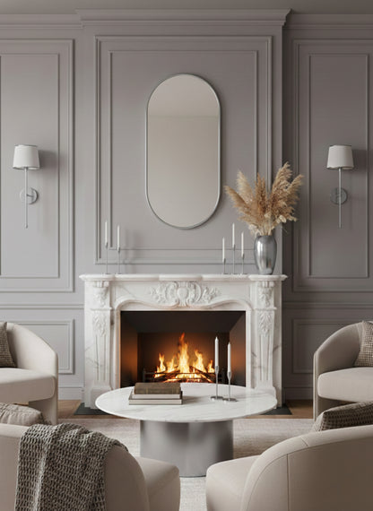 Silver capsule mirror above fireplace mantel in elegant living room.