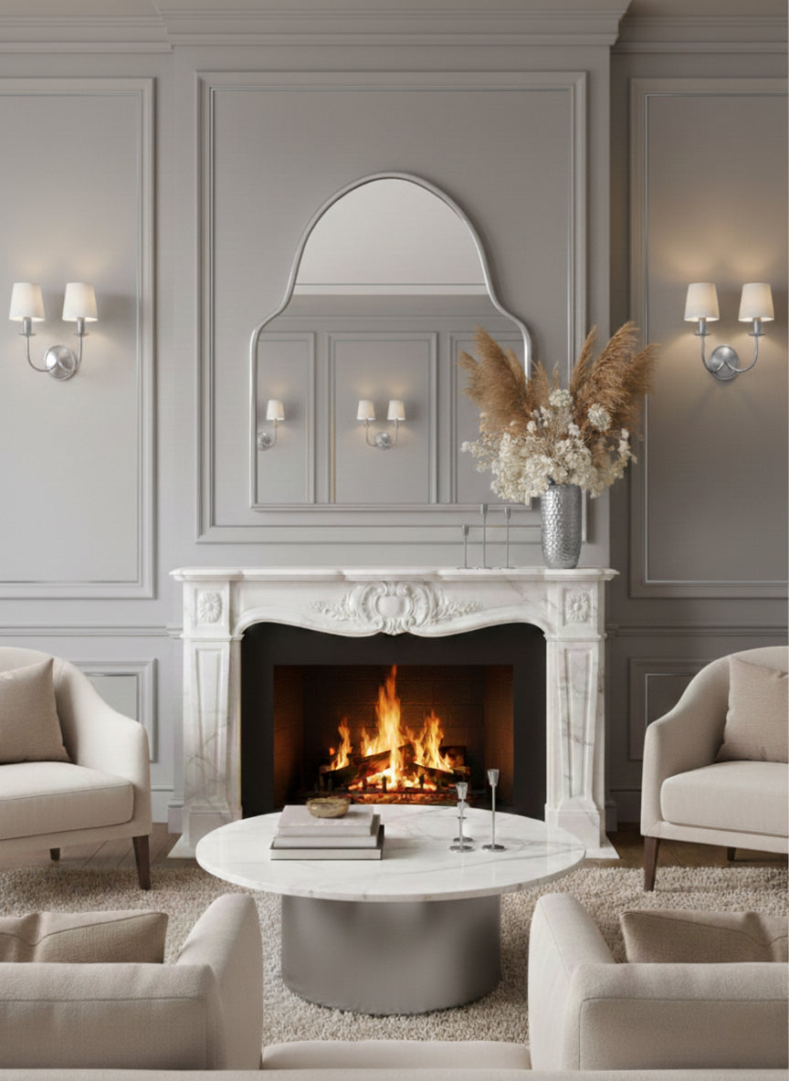 Silver brass arch mirror above classic fireplace mantel.