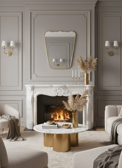 Scalloped brass mirror above classic marble fireplace