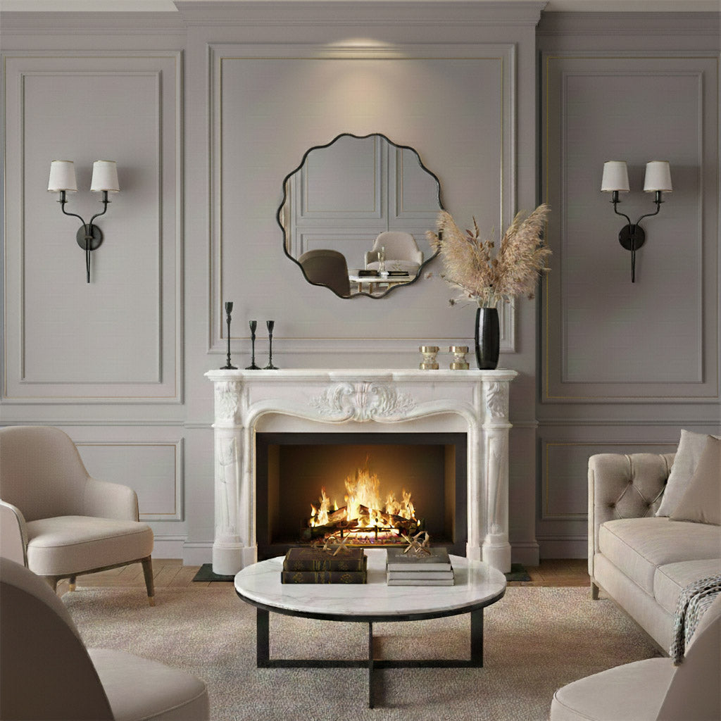 Round wavy black mirror above fireplace in elegant living room.
