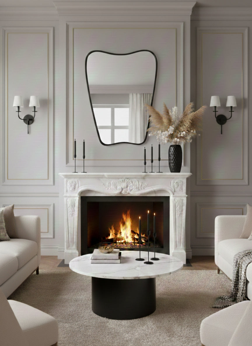 Wavy black mirror above classic white fireplace mantel in elegant living room.