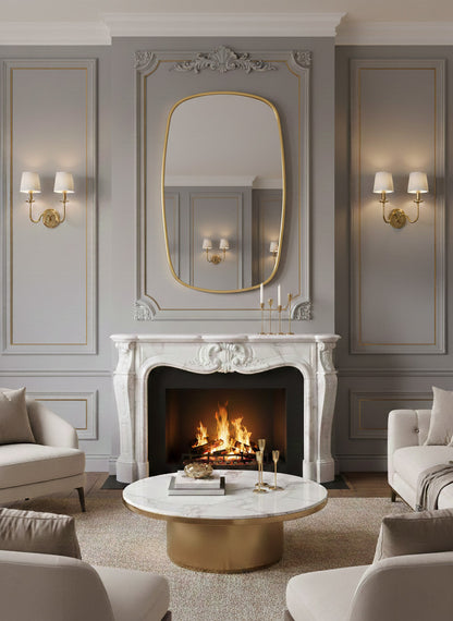 Oblong brass mirror above classic marble fireplace