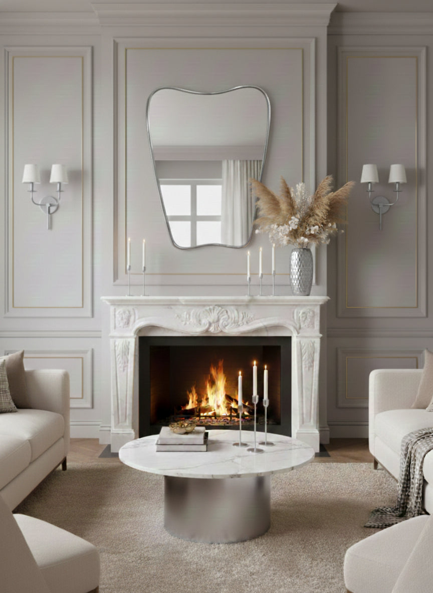 Irregular brass mirror above classic fireplace mantel in elegant living room.