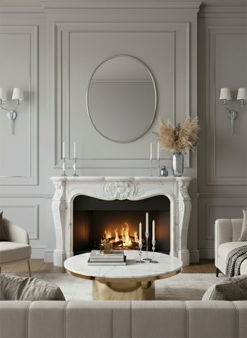 Silver brass oval mirror above fireplace mantel in elegant living room.