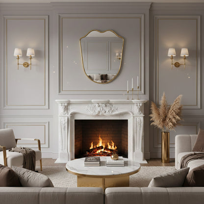 Wavy brass wall mirror above marble fireplace mantel