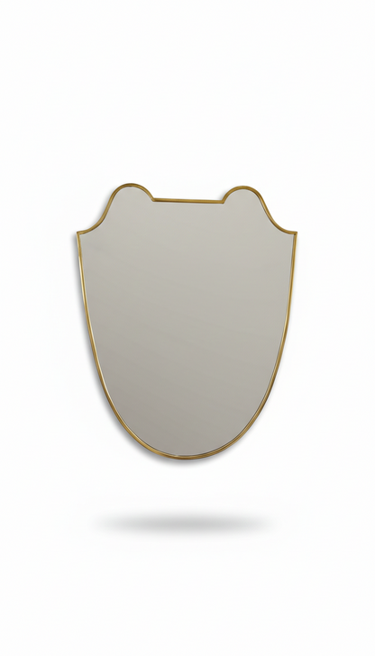 Curved brass mirror on white background