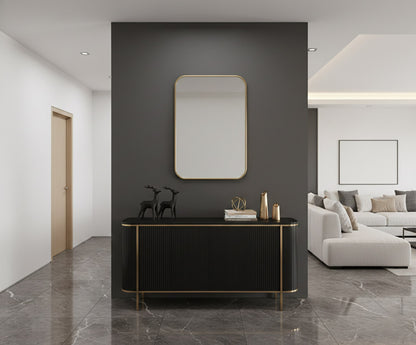 Rectangular brass mirror above black console table.