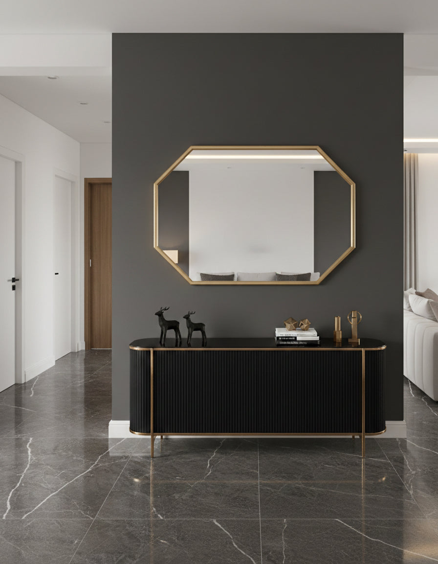 Octagon brass mirror above black console table.