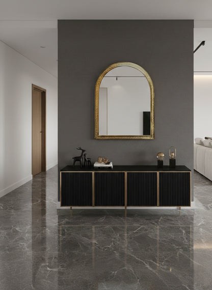 Brass arch mirror above black console