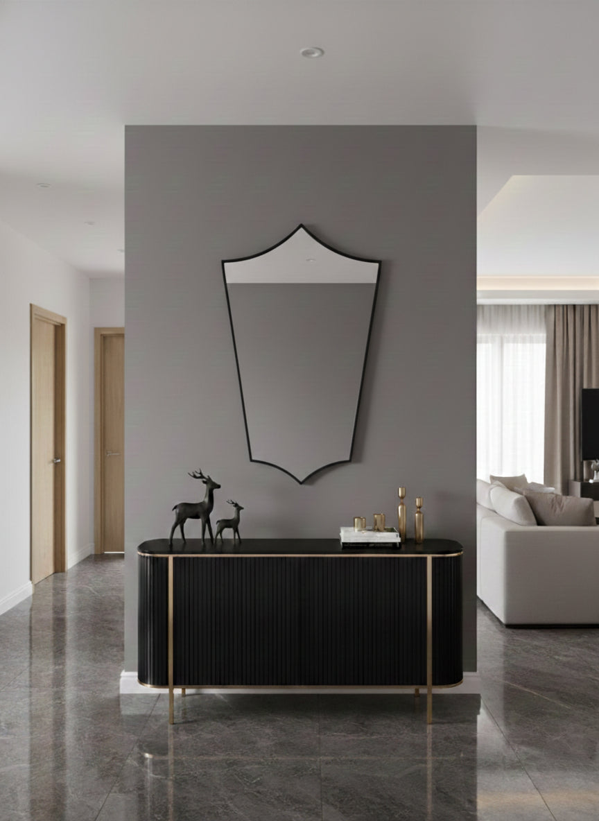 Brass mirror above black console