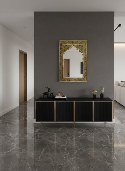 Brass arch mirror above black console