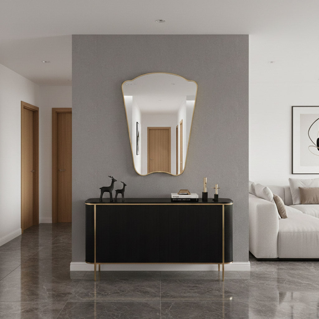 Italian irregular brass mirror mounted above black console in modern hallway