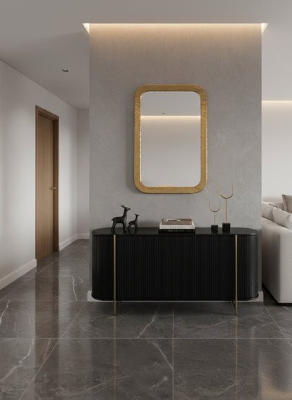 Rectangular brass mirror above black console
