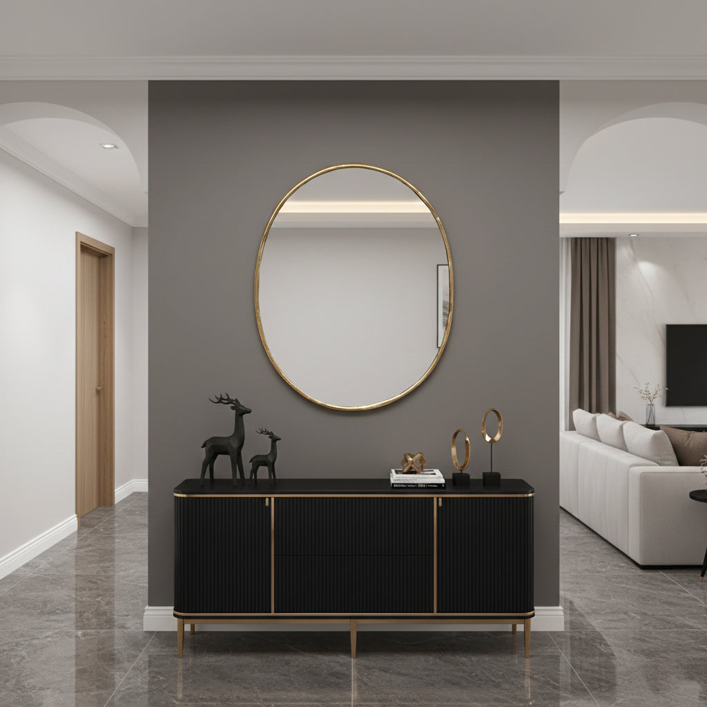 Oval brass wall mirror styled above a modern console table