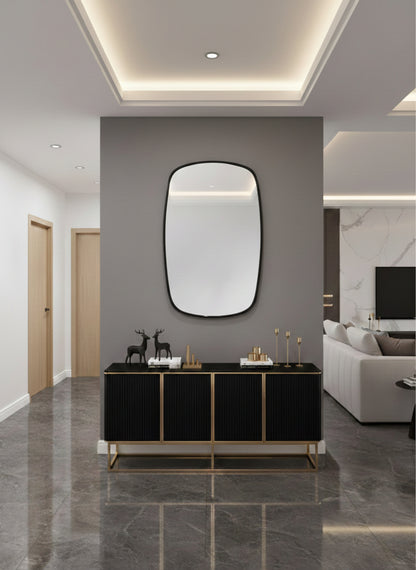 Brass mirror above black console