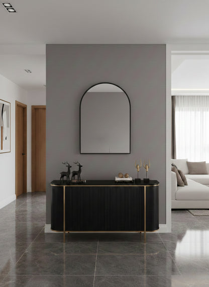Italian arch brass mirror above black console