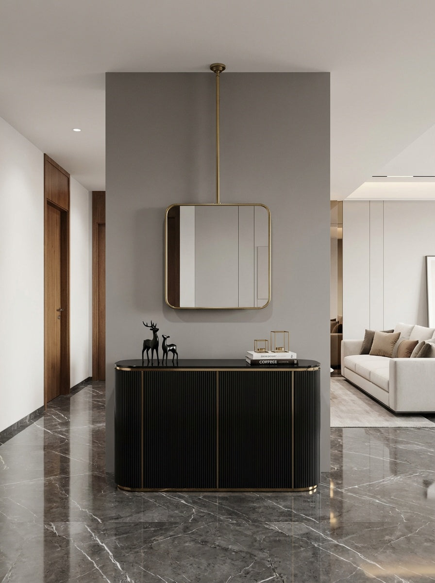 Suspended square brass mirror above black console in modern entryway.