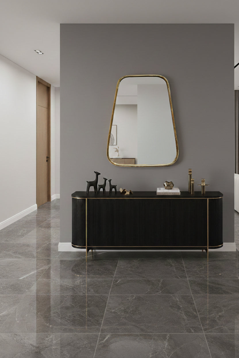 Asymmetrical brass mirror above black console