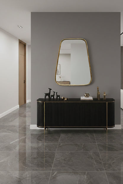 Asymmetrical brass mirror above black console