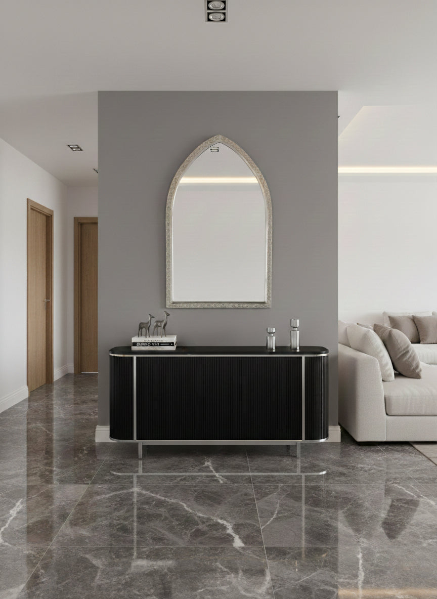 Arch brass mirror above black console