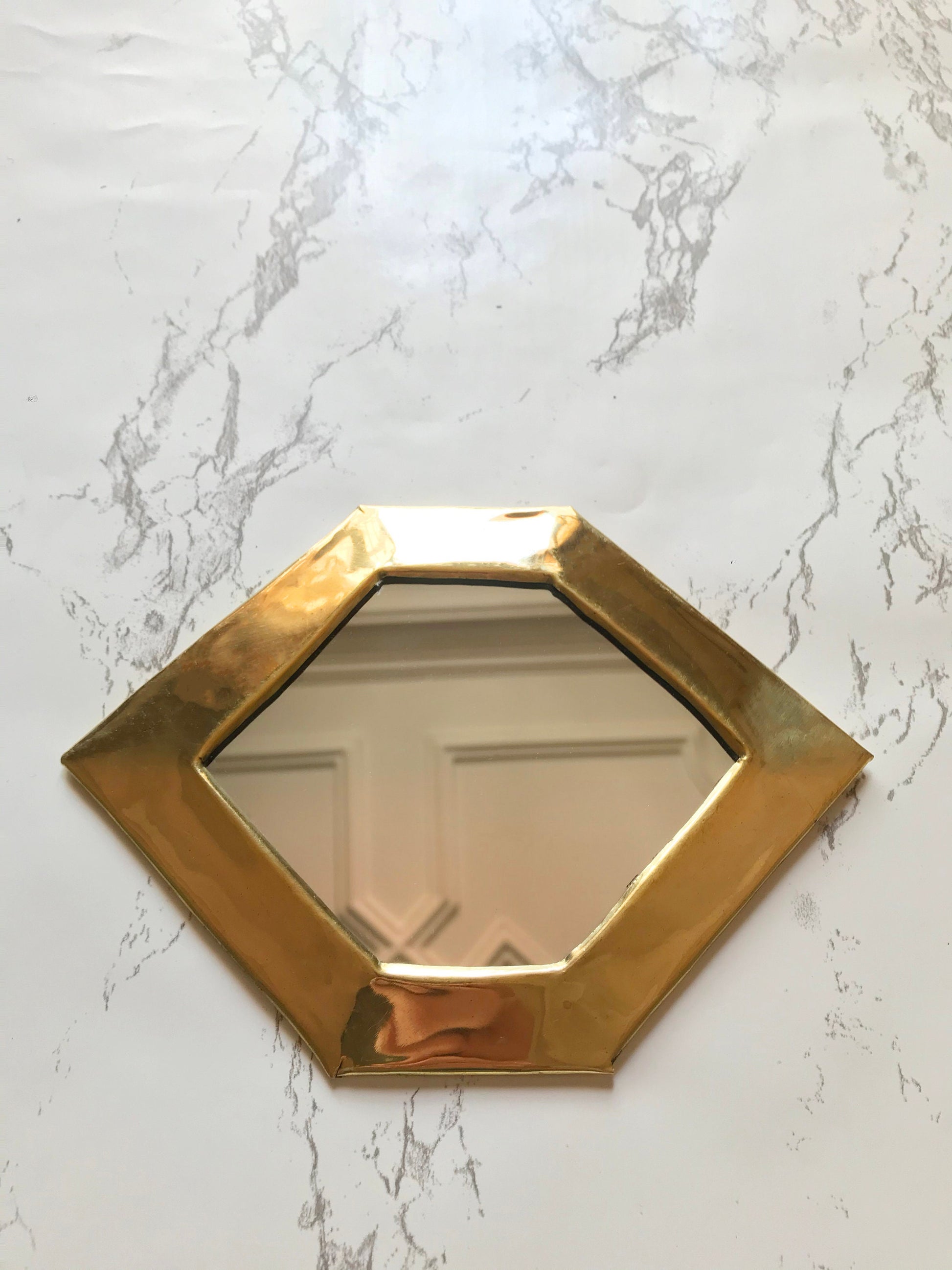 a mirror that is on a wall near a door