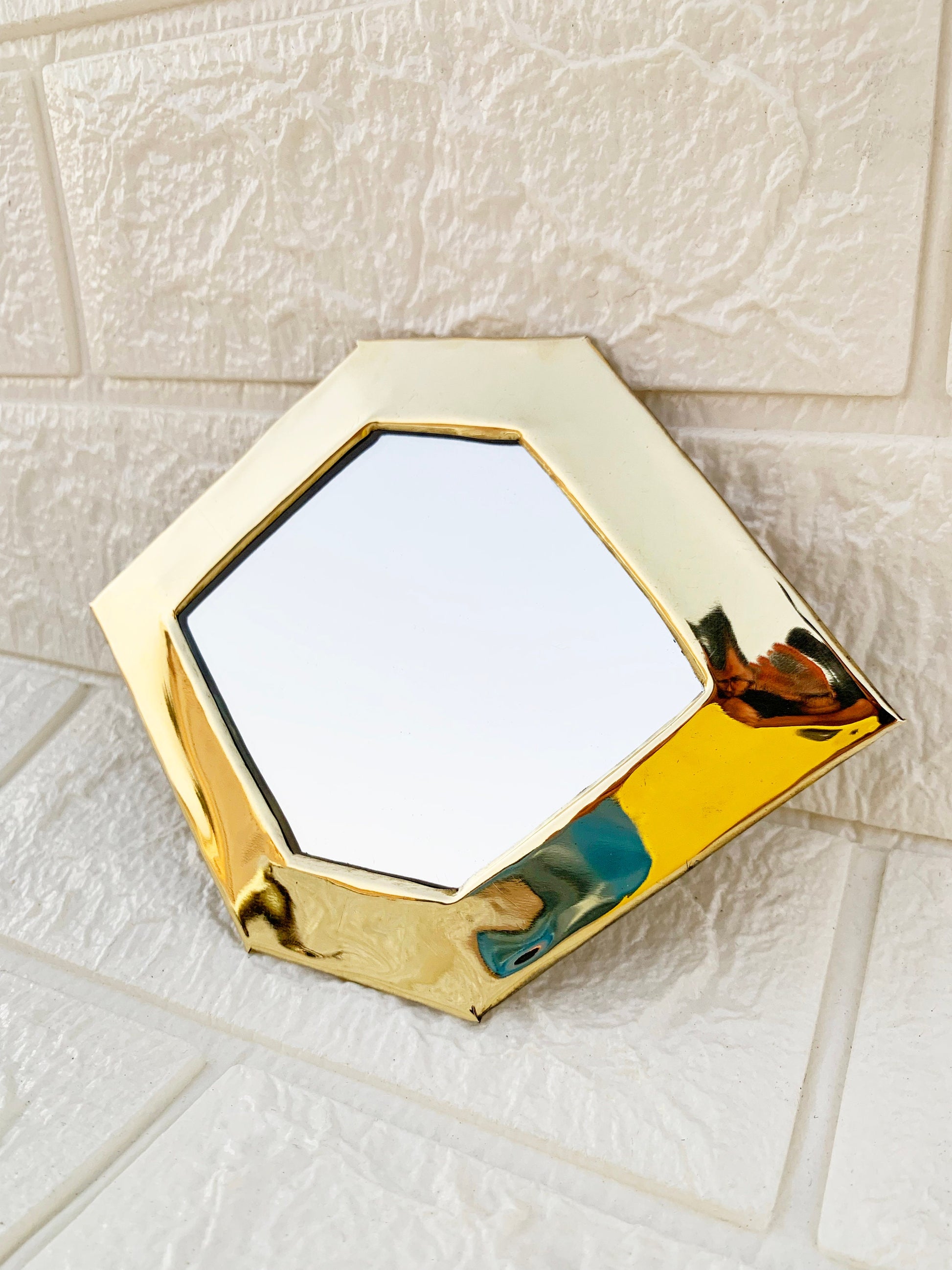 a mirror sitting on top of a white tiled floor