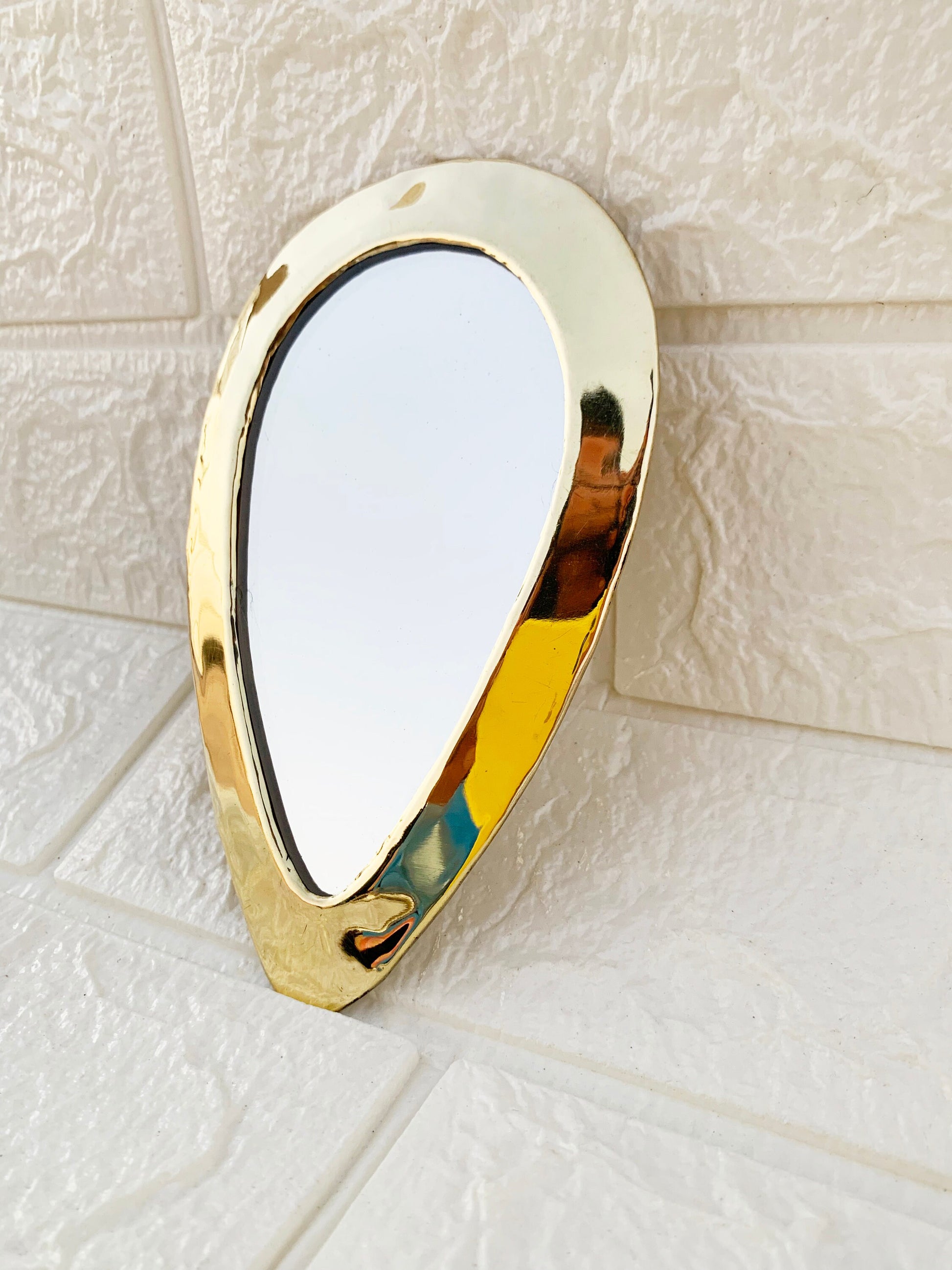 a mirror that is on the side of a wall