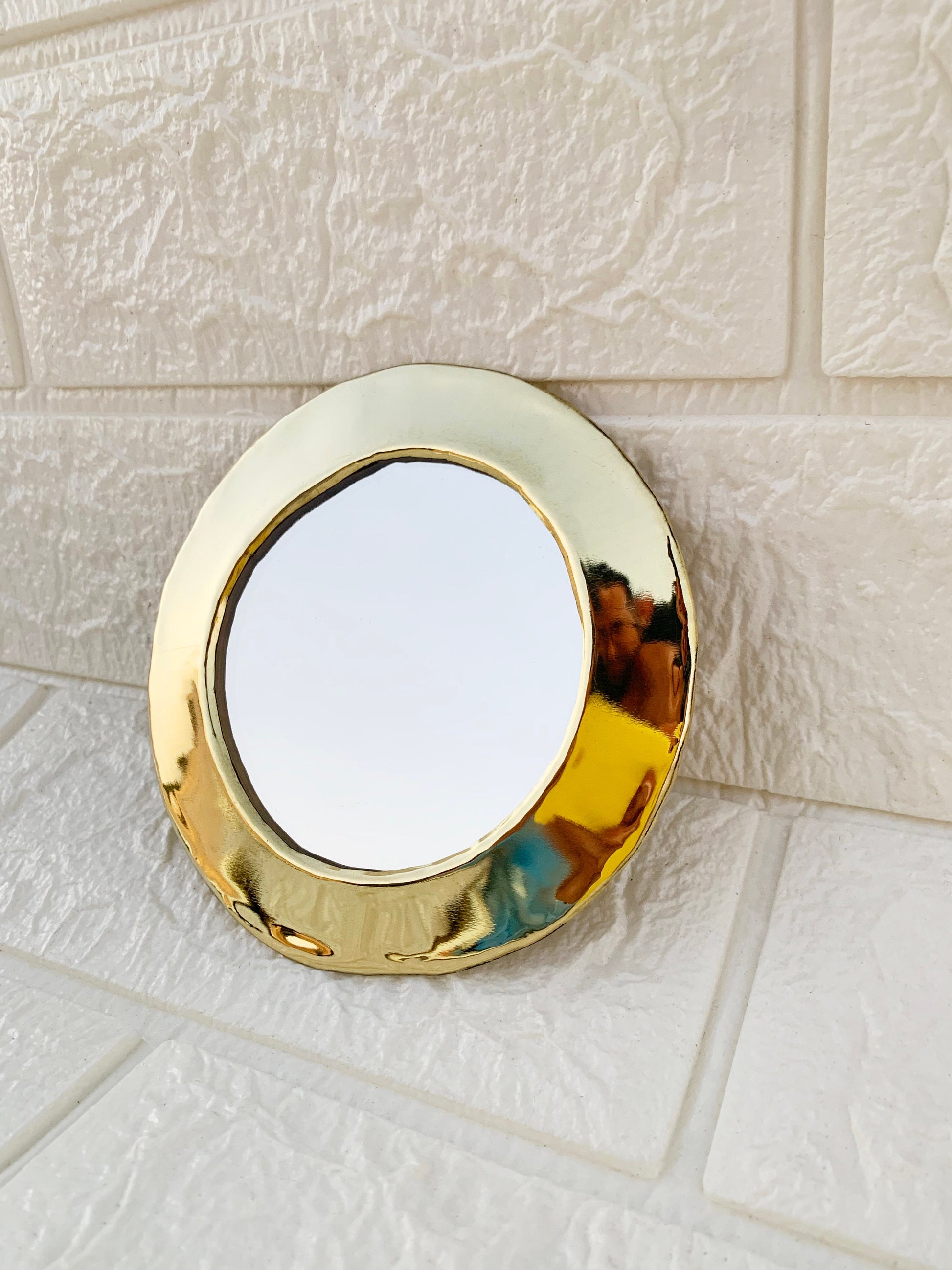 a mirror that is sitting on a tile floor