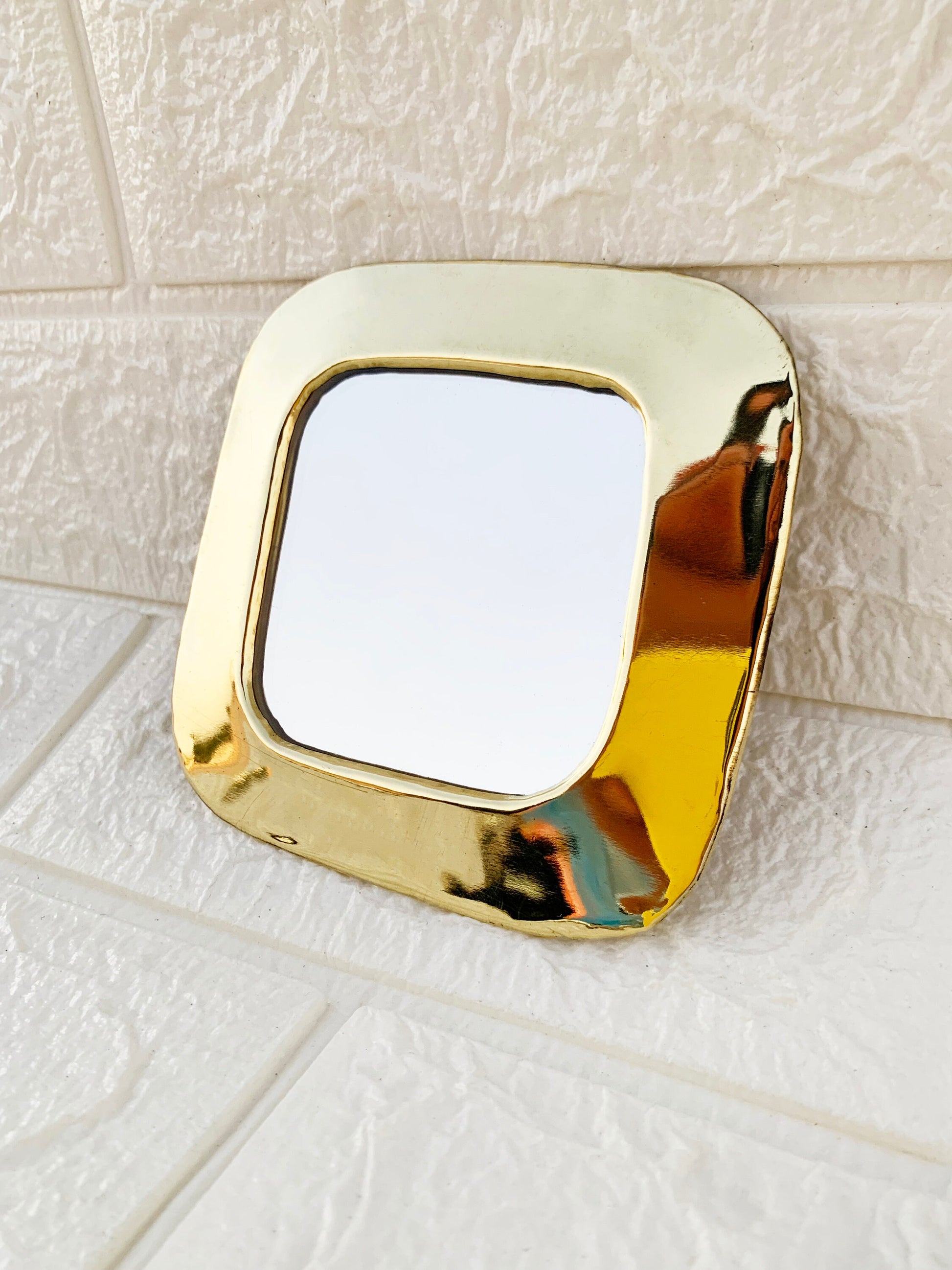 a mirror that is sitting on a tile floor