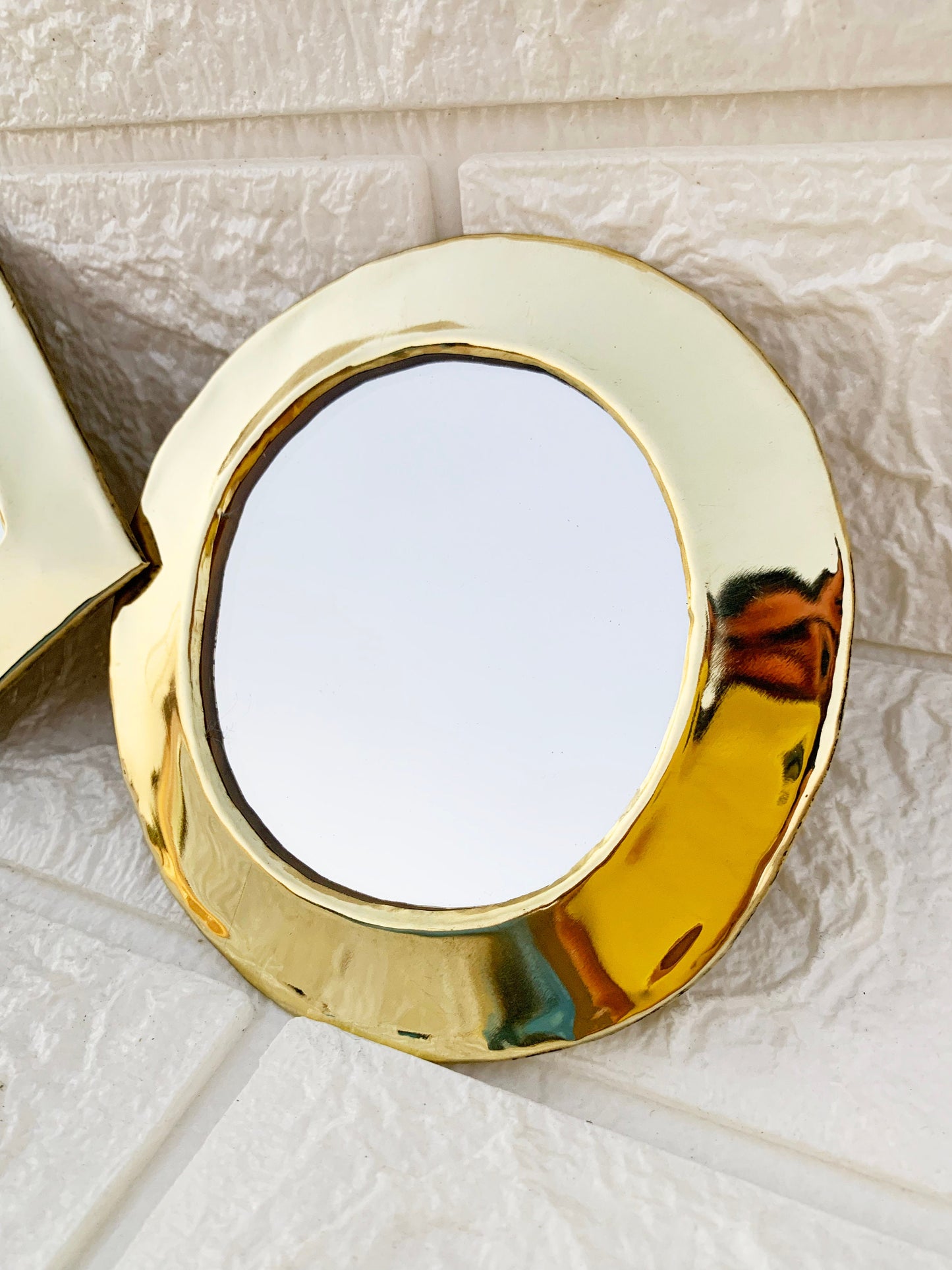 a mirror sitting on top of a white tile floor