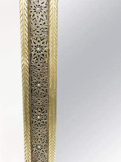 a tall metal vase with intricate designs on it