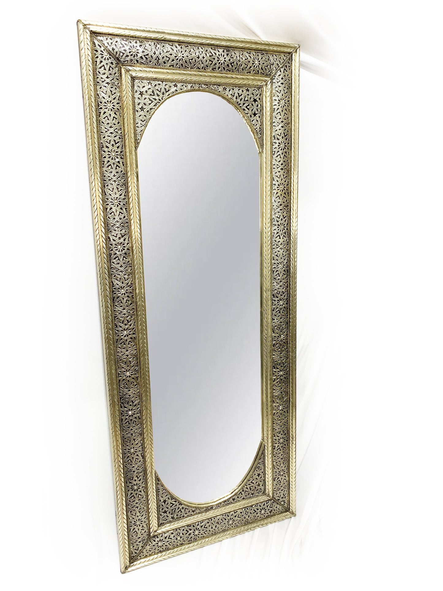 a gold framed mirror on a white wall