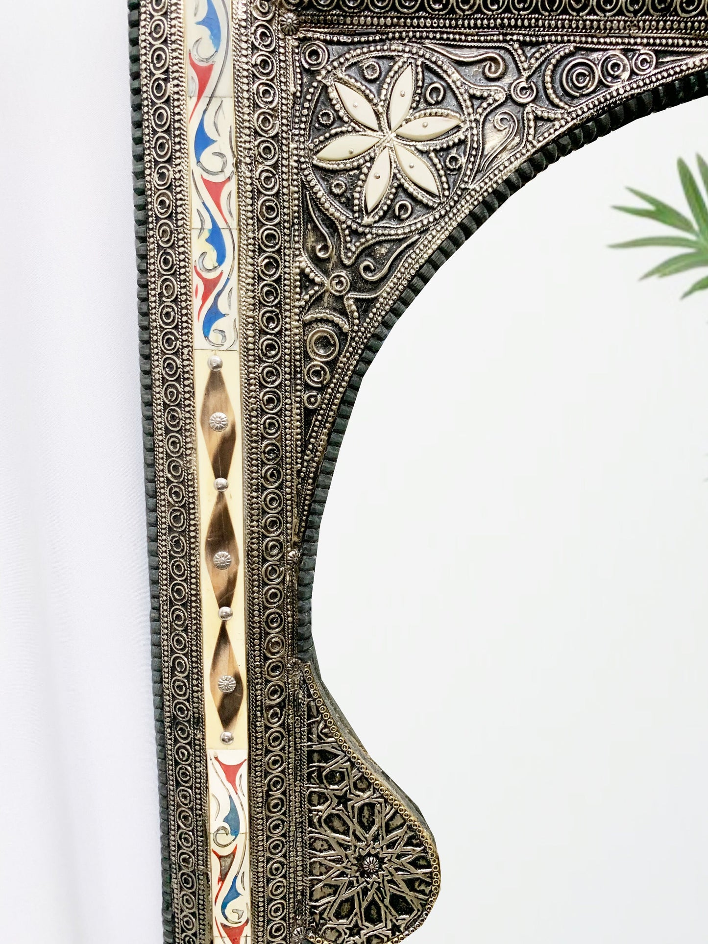 a mirror with a decorative design on it