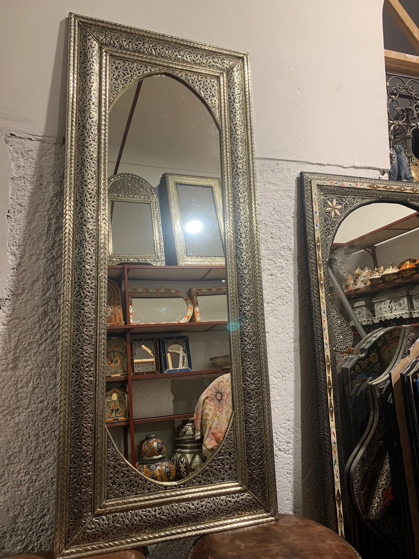 a large mirror sitting on top of a wooden table