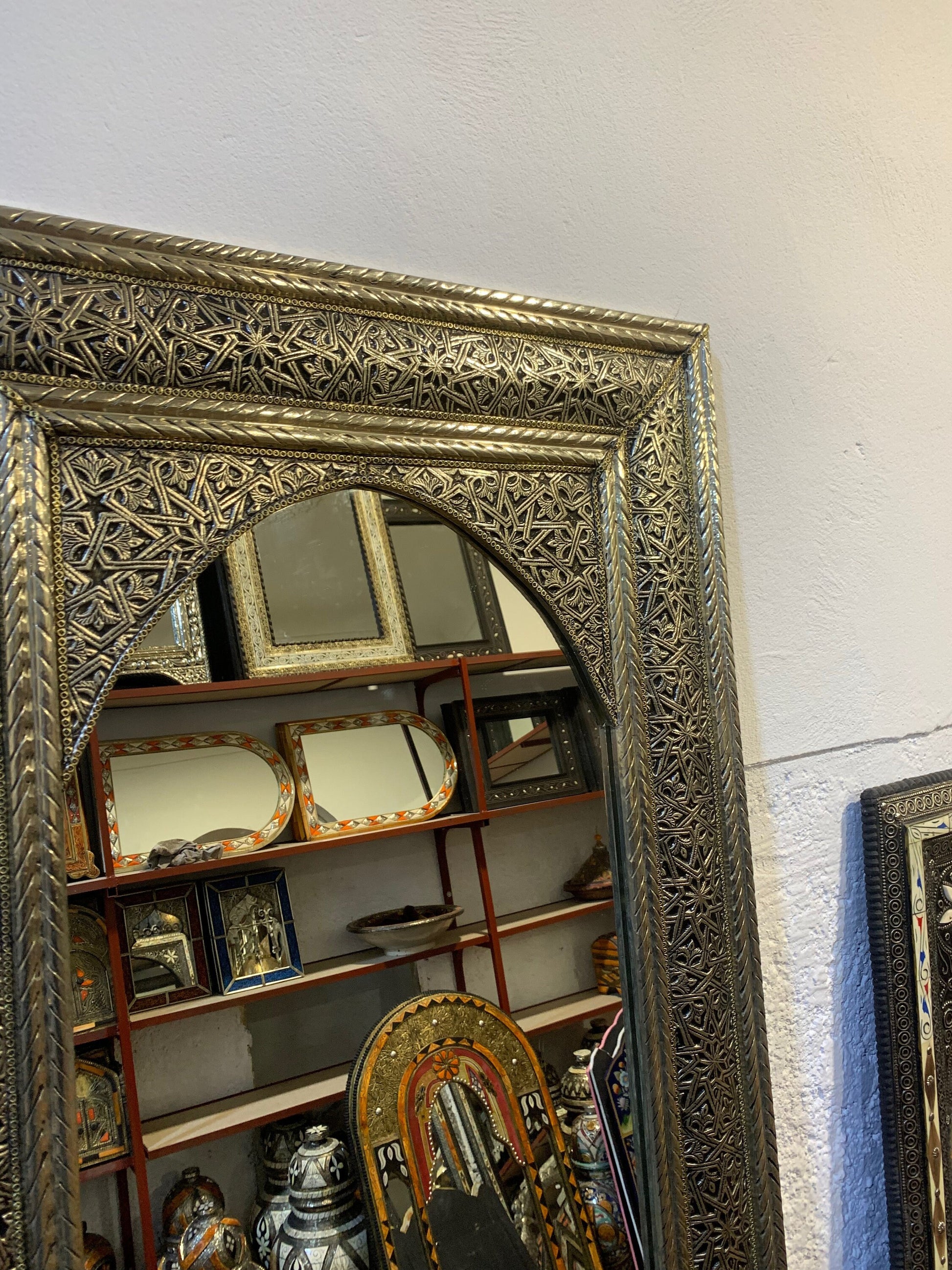 a mirror that is on top of a shelf