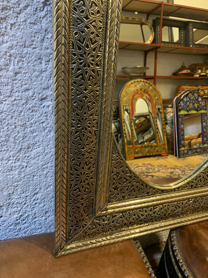 a mirror sitting on top of a wooden table