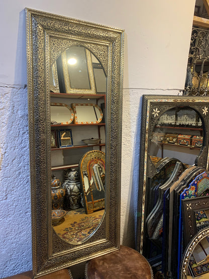 a large mirror sitting on top of a wooden table