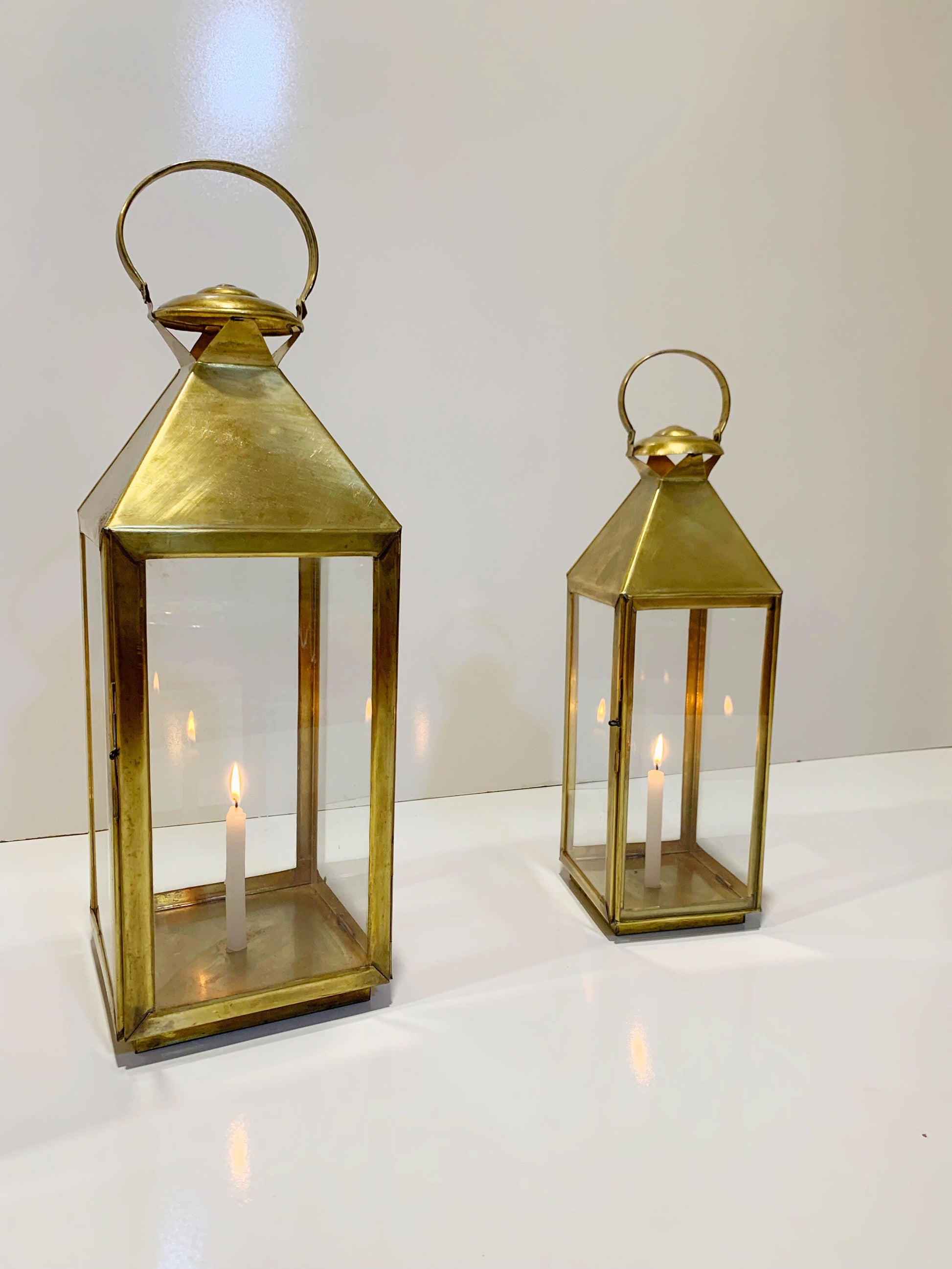 a couple of gold lanterns sitting on top of a table