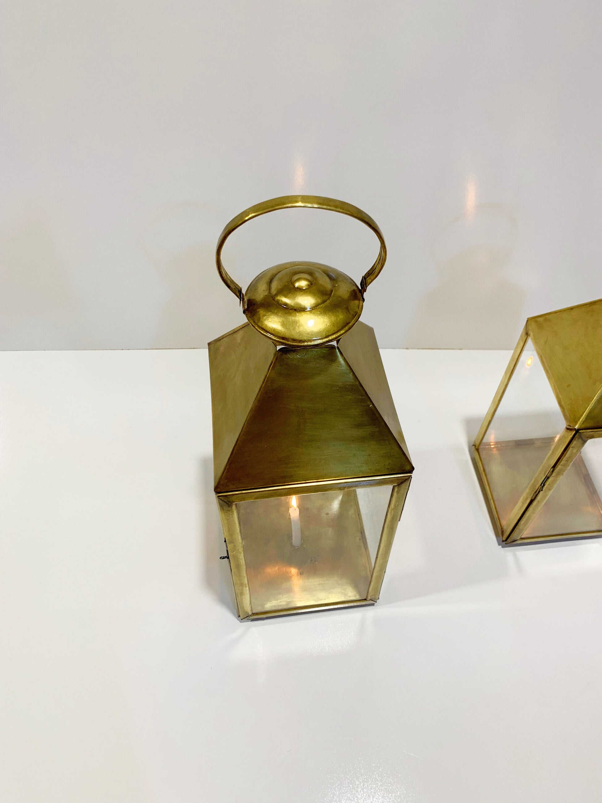 a small gold lantern sitting on top of a white table