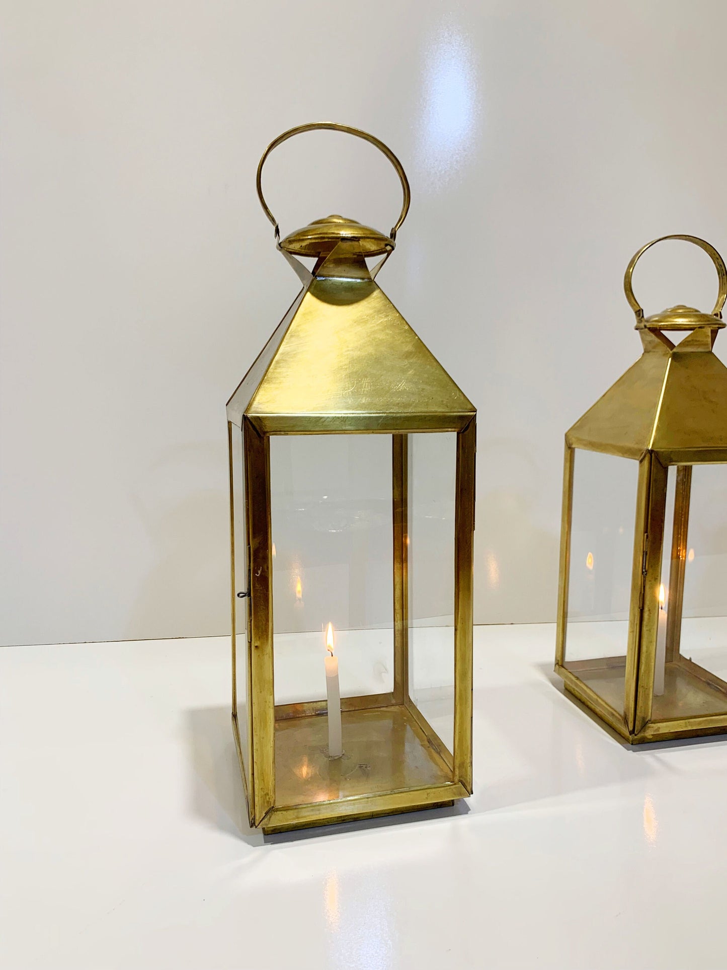 a couple of gold colored lanterns sitting on top of a table