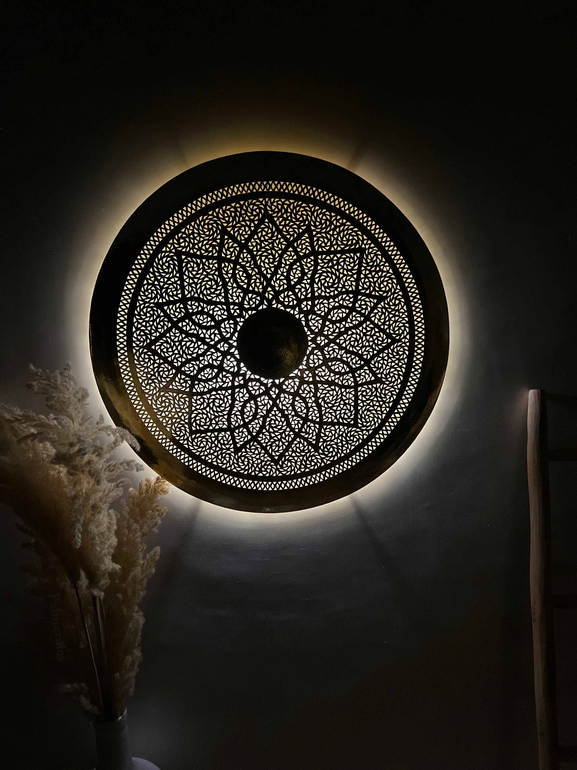 a decorative circular light fixture in a dark room