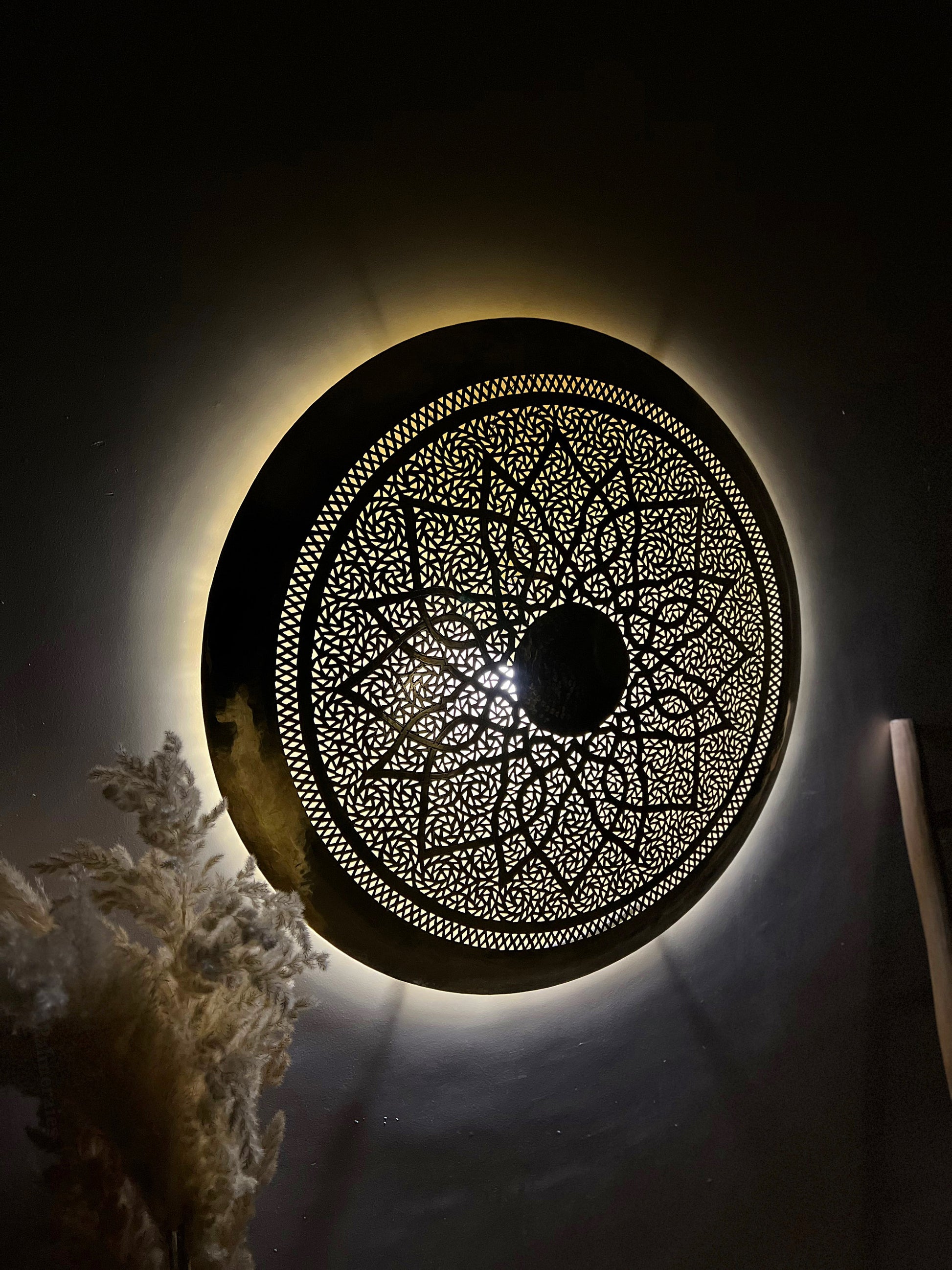 a circular light fixture in a dark room