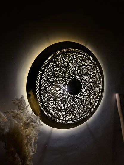 a circular light fixture in a dark room