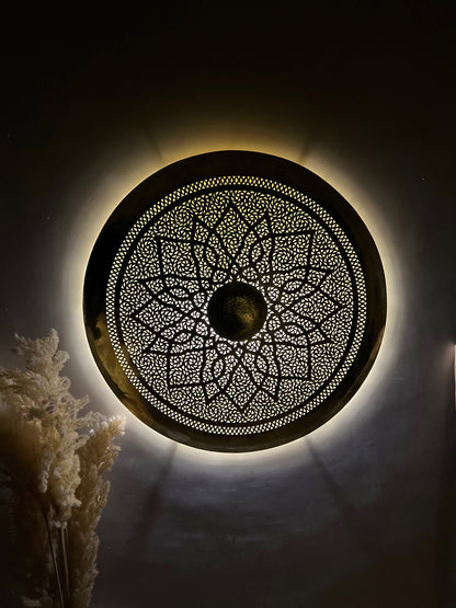 a circular light fixture mounted on a wall